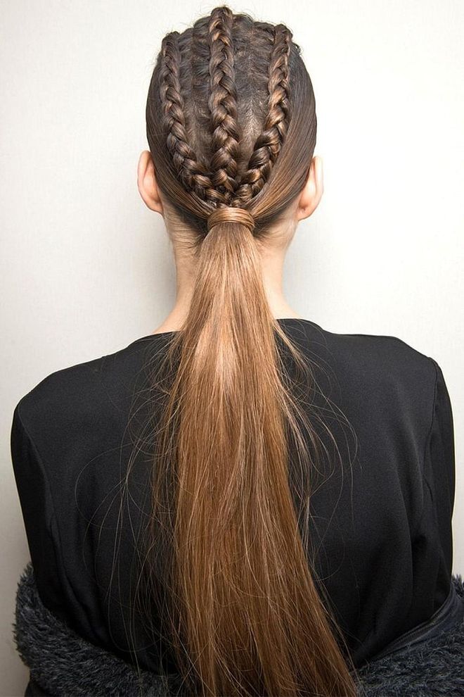 At Balmain, hairstylist Sam McKnight braided three or four cornrows along the center of the head ("in an imaginary mohawk"), then pulled the hair back into a tight ponytail. Extensions were added for length, so that the tails reached the middle of the models' backs. A root cover-up powder in shade darker than the models' hair was used along the braids to cover the skin, and then McKnight's namesake styling products (launching later this year) added the grit and hold needed to keep the look in place. "She's tougher and more warrior-like than in the past," said the hairstylist. 