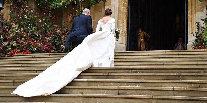 Princess Eugenie's long train blew in the wind as she entered St. George's Chapel.
