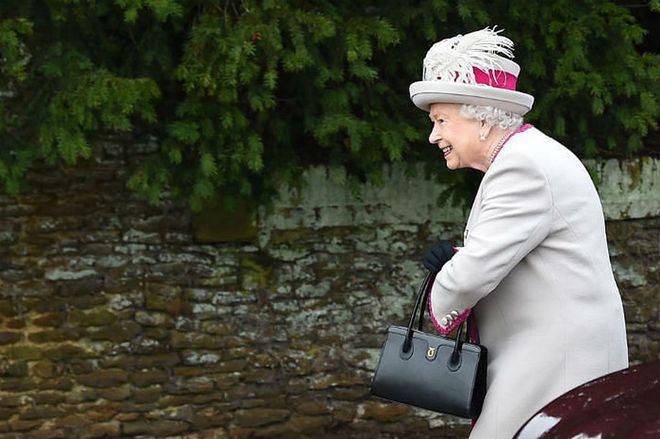 The Queen was spotted arriving in a cream outfit with fuchsia pink accents.