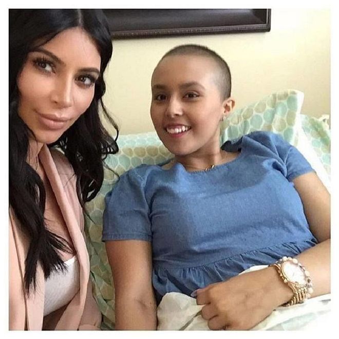 Why is this girl smiling? It's because Kim Kardashian took time out of her busy schedule to visit her in person. With Mason Disick, 5, tagging along with his aunt, the two fulfilled the girl's, Anissa, Make-a-Wish Foundation request.
"Mason & I spent the day with this beautiful soul, Anissa! Thank you Make-A-Wish for this special day!" Kim wrote on Instagram. And now she's got us smiling from ear-to-ear, too. Photo: Facebook