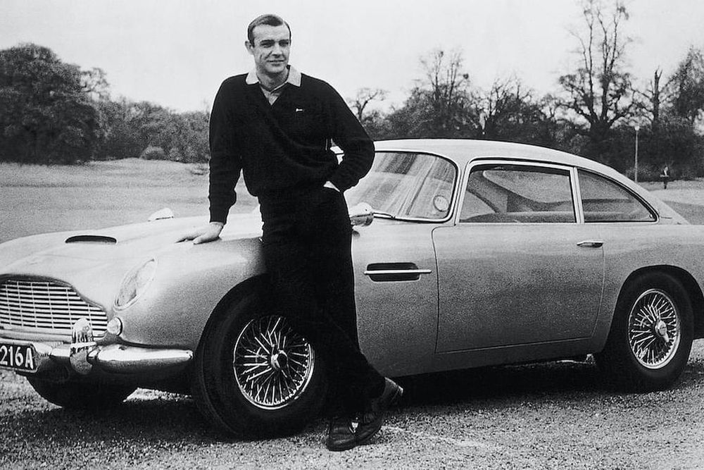 Actor Sean Connery, the original James Bond, is pictured here on the set of Goldfinger with one of the fictional spy's cars, a 1964 Aston Martin DB5. (Photo: Getty Images)