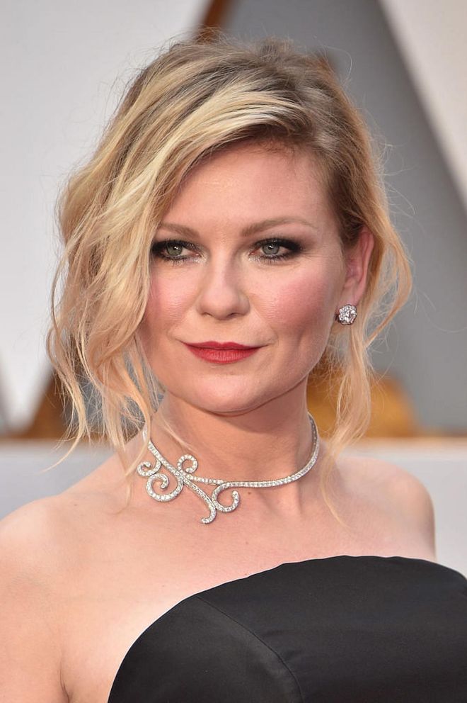 Kirsten Dunst jazzes up the classic smokey eyes and red lips combo with tousled tresses for her signature cool-girl vibe. 

Photo: Getty Images