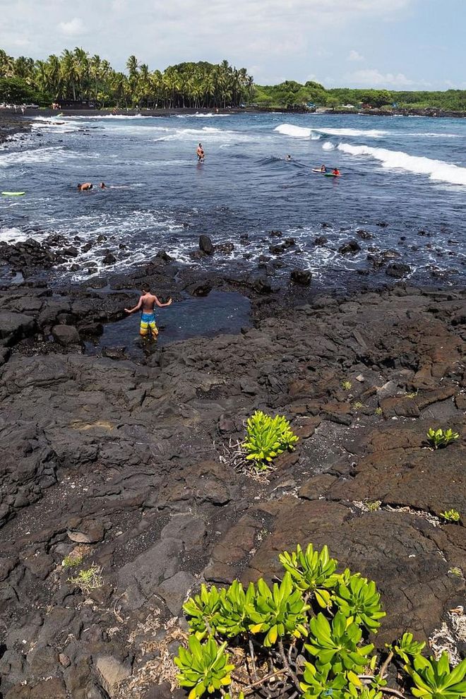 A short drive from this town is the famous Punaluu Black Sand Beach, which is the result of volcanic activity. You see, the sand is made out of basalt, which is created by lava flowing into the ocean and exploding in the cool water. The green plants and blue water pop in comparison to the dark shoreline.