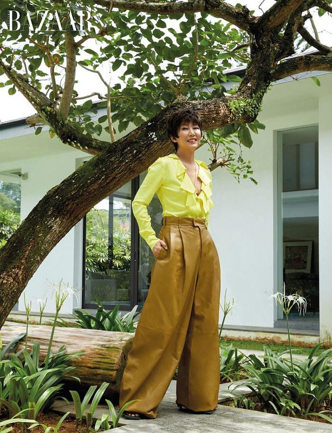 Dressed in a silk blouse, leather trousers and heeled sandals, all from Bottega Veneta, June Goh-Rin takes us on a little tour around her backyard, where her family winds down.