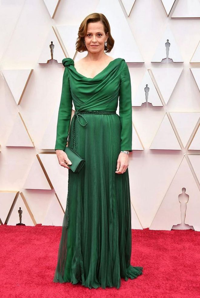 In an emerald Christian Dior Haute Couture gown.

Photo: Amy Sussman