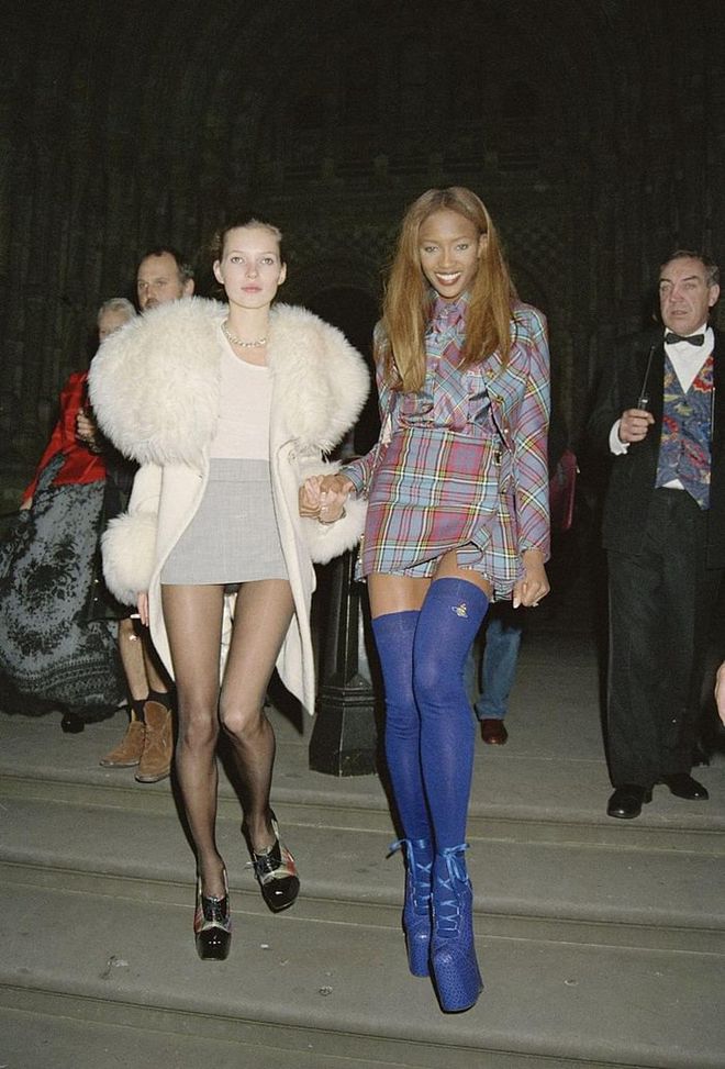The supermodel duo exits a London Fashion Week party in 1993. Photo: Getty 