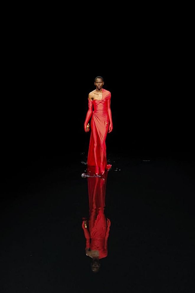 This striking red look at Balenciaga reflected in the water on the runway.