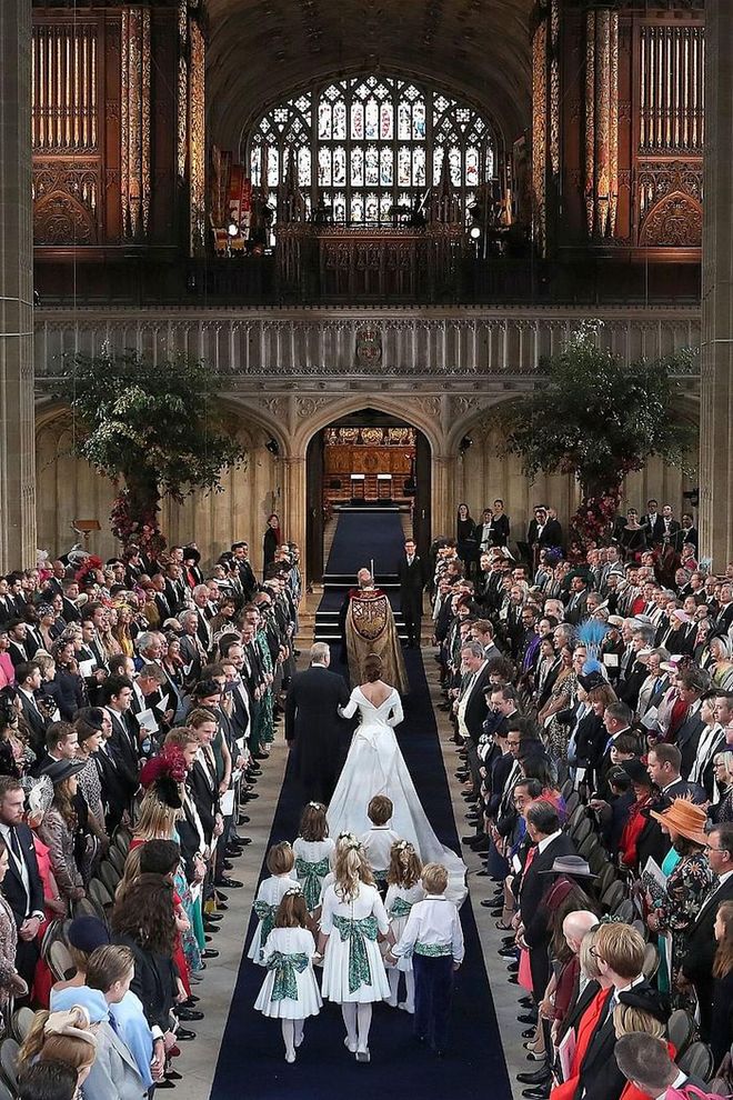 Guests watch as Princess Eugenie walks down the aisle at St. George's Chapel.