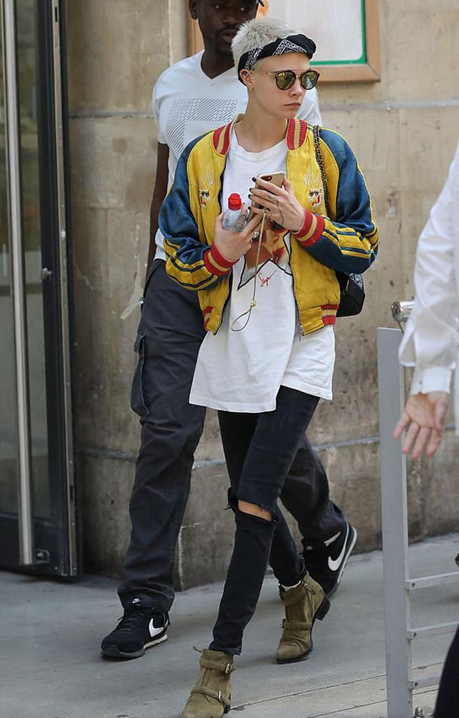Fashion is never dull with Cara Delevingne. The rising movie actress paired an oversized shirt with ripped jeans, topping the casual chic outfit with a mustard bomber as she strut down the LA streets. Photo: Getty