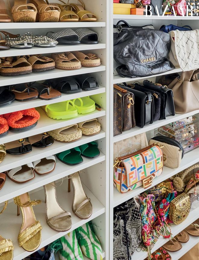 The open shelves inside the guest bedroom house Kausar’s shoes and bags collection, organised by height.