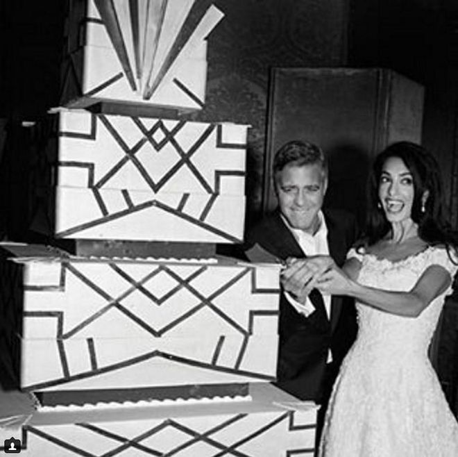 Would you expect anything less than classic elegance from Clooney and Alamuddin? The couple cut into a four-tiered, square-style art deco chocolate wedding cake at their Venice wedding. Photo: Instagram