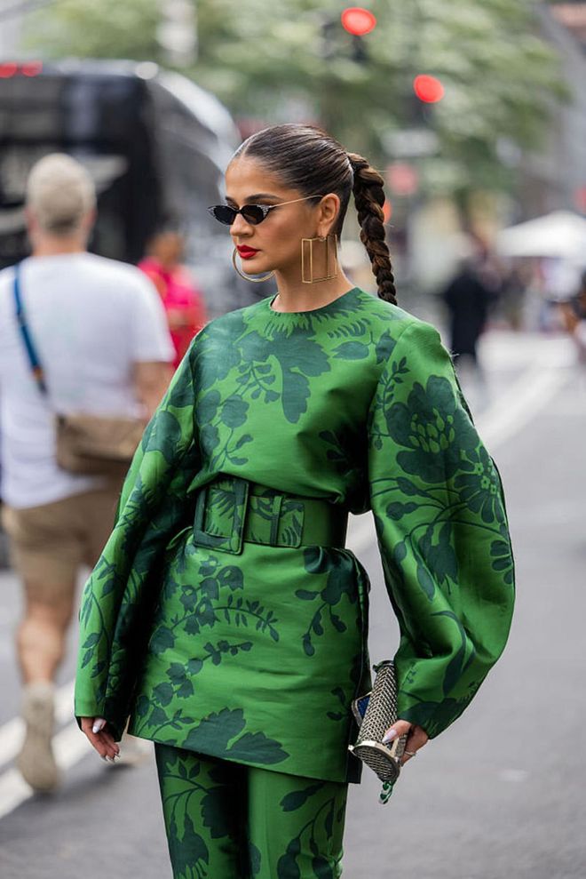 NEW YORK, NEW YORK - SEPTEMBER 14: Thássia Naves wearing a long-sleeved blouse, belt and pants in matching green and floral patterns. (Photo by Christian Vierig/Getty Images)
