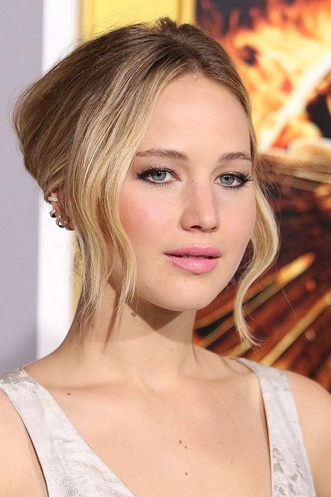 Leave wavy pieces out of your bun for a soft, face-framing updo like Jennifer Lawrence’s.