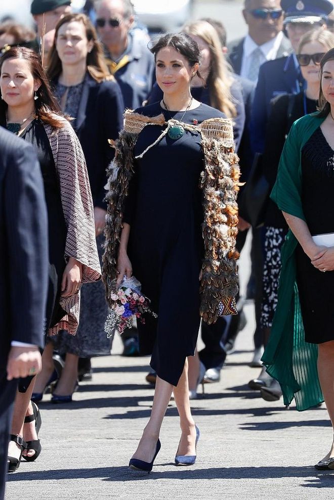 The Duchess of Sussex attended a formal powhiri and luncheon at Te Papaiouru Marae in a Stella McCartney navy asymmetric crêpe dress and blue Manolos. 