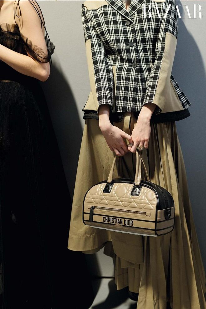 (LEFT) Tulle dress; (RIGHT) Check‘n’Dior dry virgin wool jacket; cotton trench skirt; macrocannage embossed calfskin Dior Vibe Zip bowling bag (small); gold finished metal and crystal D-Renaissance rings, Dior