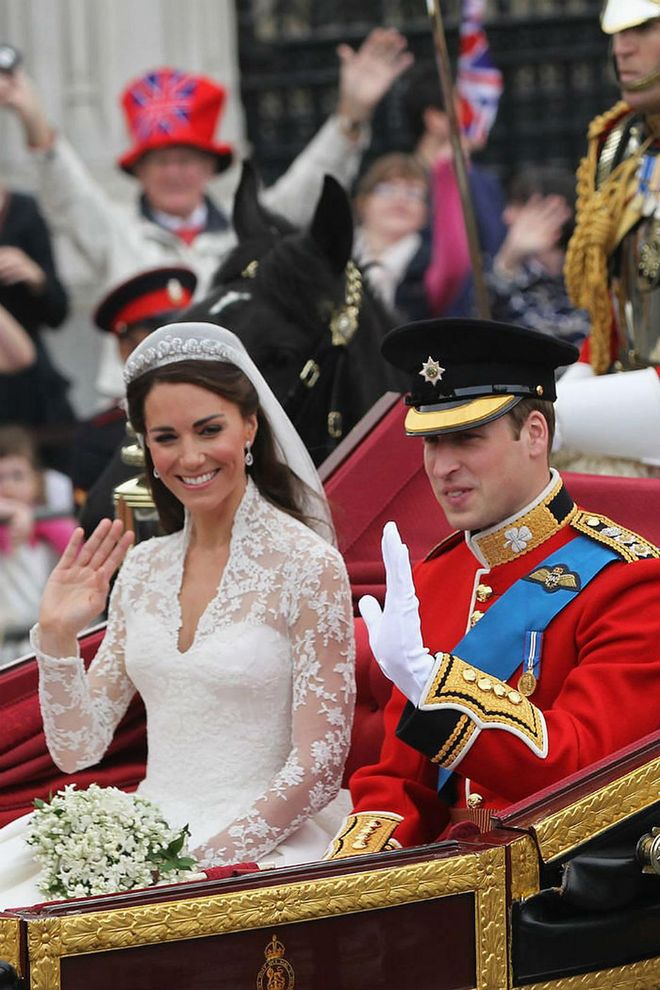 The newlyweds make their way to Buckingham Palace via an open carriage.Photo: Getty