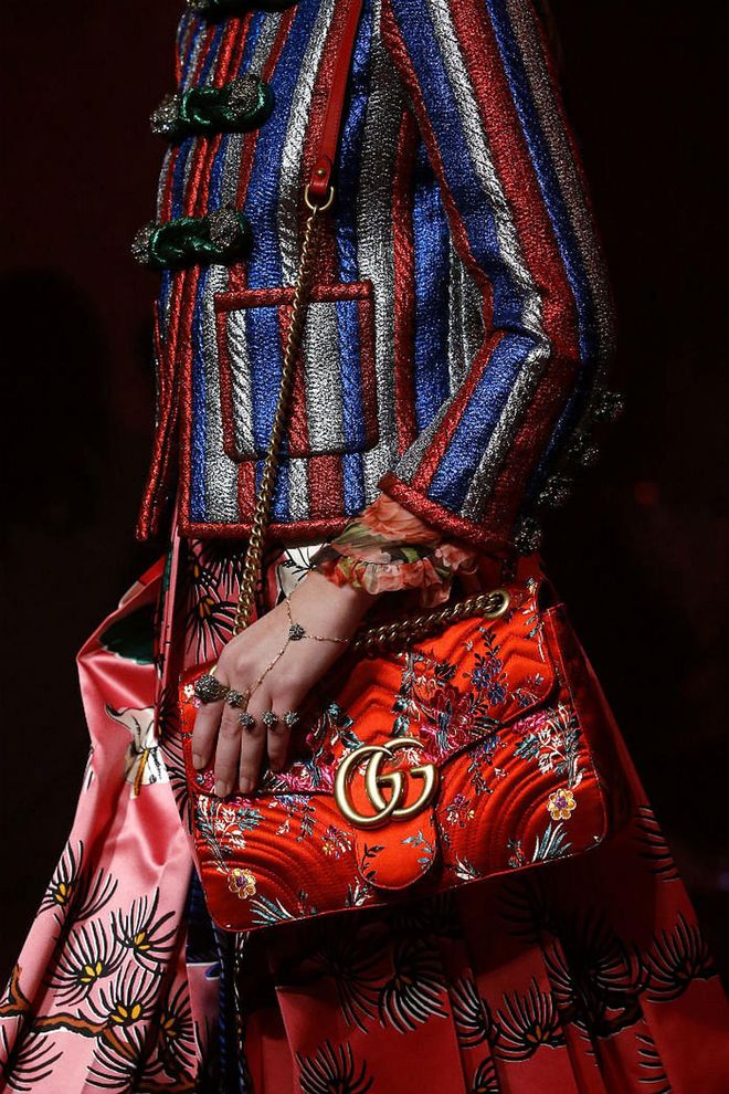 Seen at: Milan Fashion Week//Why we love it: The silken shoulder bag in fire-alarm red, boasts Oriental garden-esque details, making this number a head turner for all the right reasons. (Photo: Getty)