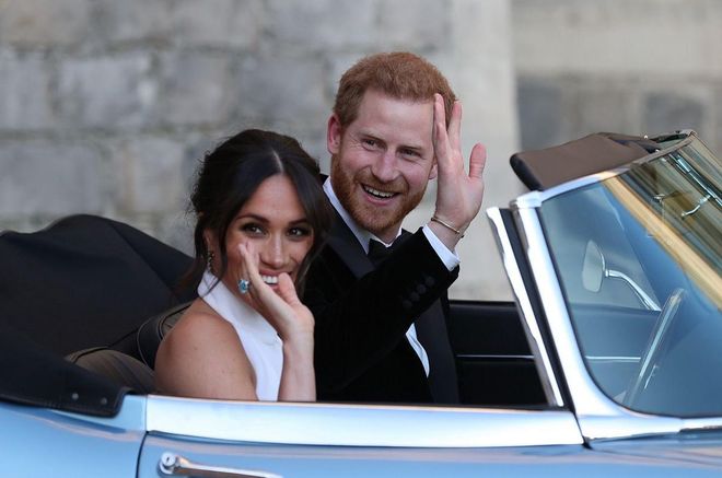 Prince Harry and Meghan Markle wave as they leave for their reception