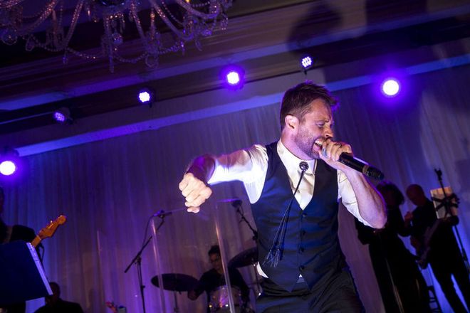 The groom couldn't help but hop on stage for a cameo performance at the reception. Photo: Lara Porzak