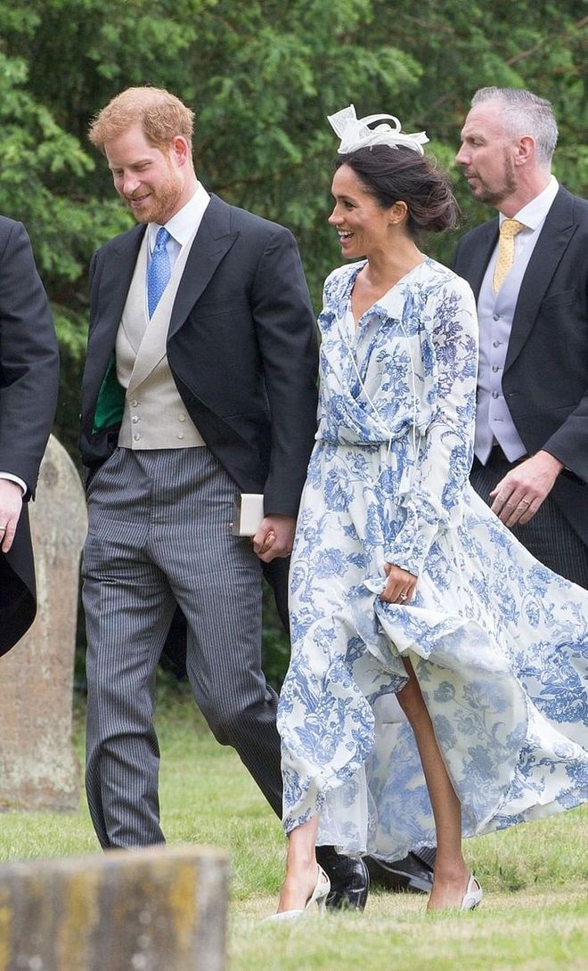 The Duchess of Sussex arrives in a powder blue Oscar De La Renta long sleeved cocktail dress, from their resort 2019 collection. Topping the look with a cream bow by Marks & Spencer and Carolina Herrera's Scala Insignia Clutch Bag in cream. 