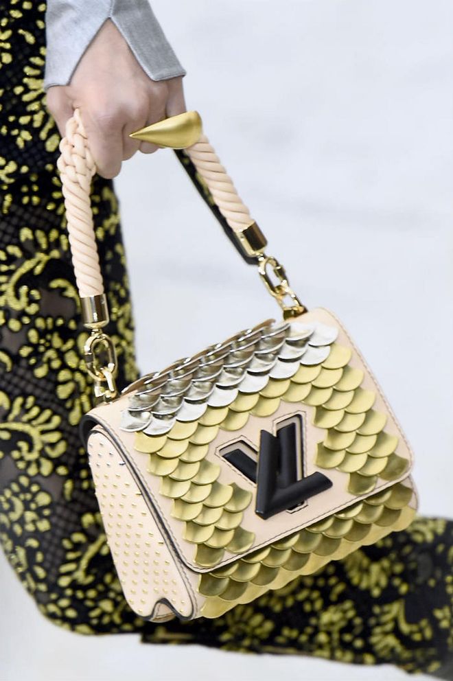 Seen at: Paris Fashion Week//Why we love it: We just know that the gorgeous rope-like handle will fall on the arms like a dream. But it's the glistening scale-like details on the bag that's got us wanting it so bad.  (Photo: Getty)