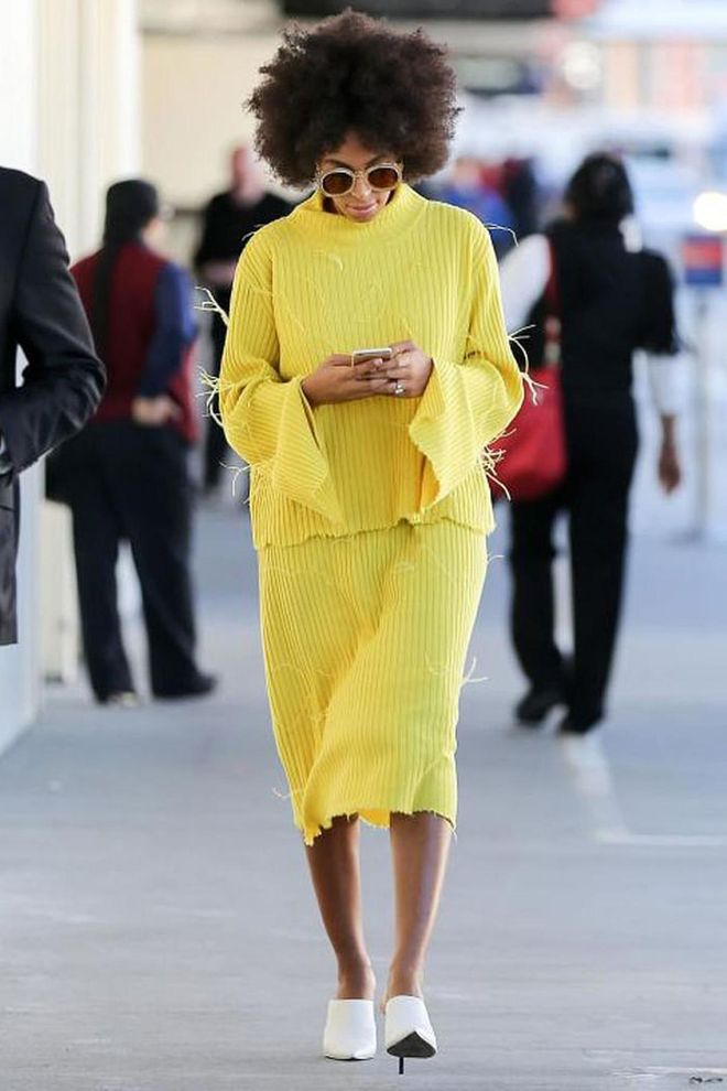 Solange Knowles looked chic in sunny yellow as she arrived at the airport.