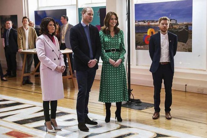The royal couple listens to a local band.

Photo: Getty