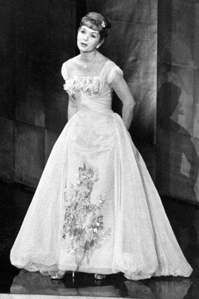 Nominated for her role in The Unsinkable Molly Brown, Debbie Reynolds brought the princess look to the red carpet and the stage for a performance during the ceremony.