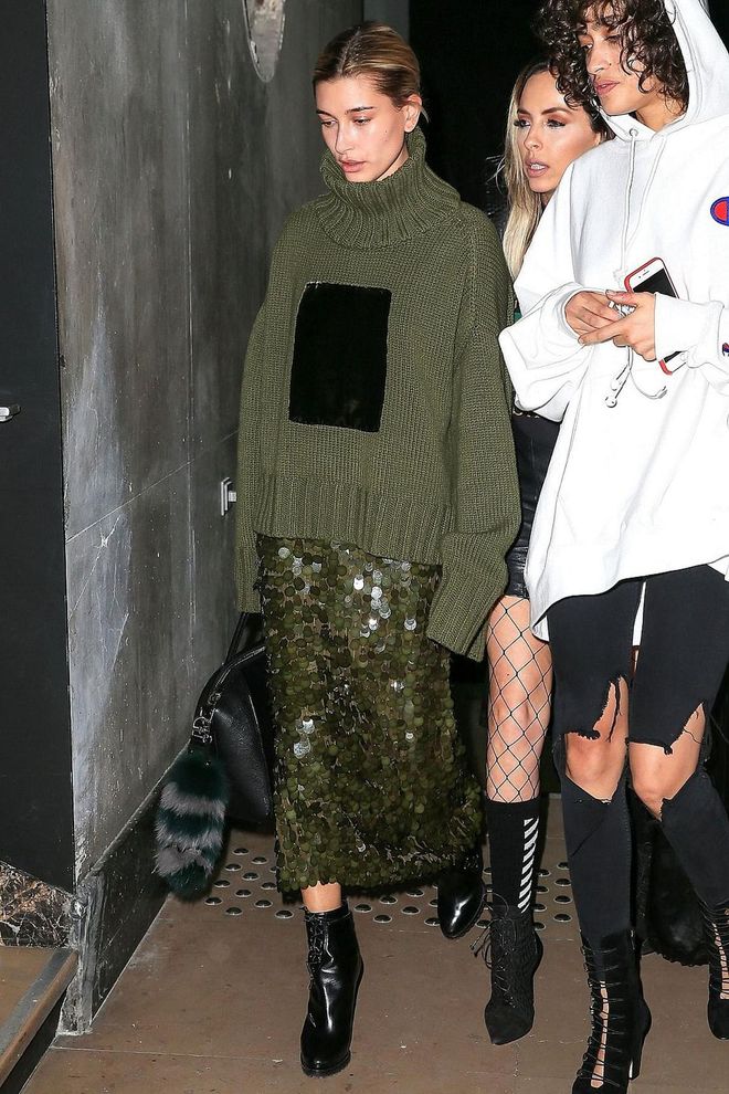 Hailey Baldwin tones down oversized paillettes by wearing them with a cozy knit, transforming a dressed up look into something far more approachable. Photo: Getty
