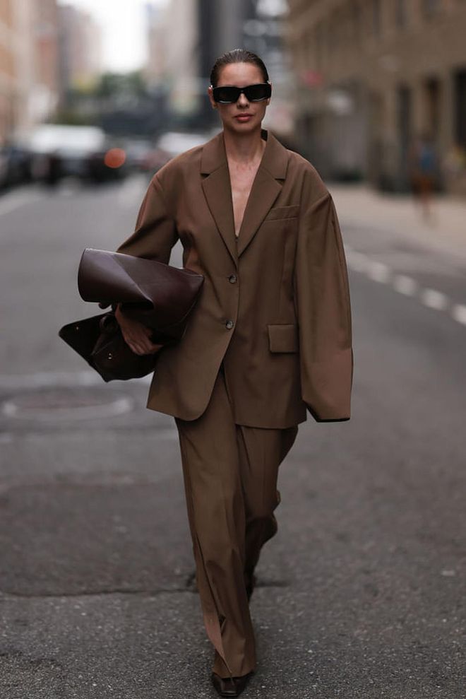 NEW YORK, NEW YORK - SEPTEMBER 09: Guest is seen outside Tibi show wearing black Loewe sunnies, brown colored The Frankie Shop suit, brown leather handbag and brown leather flats on September 09, 2023 in New York City. (Photo by Jeremy Moeller/Getty Images)