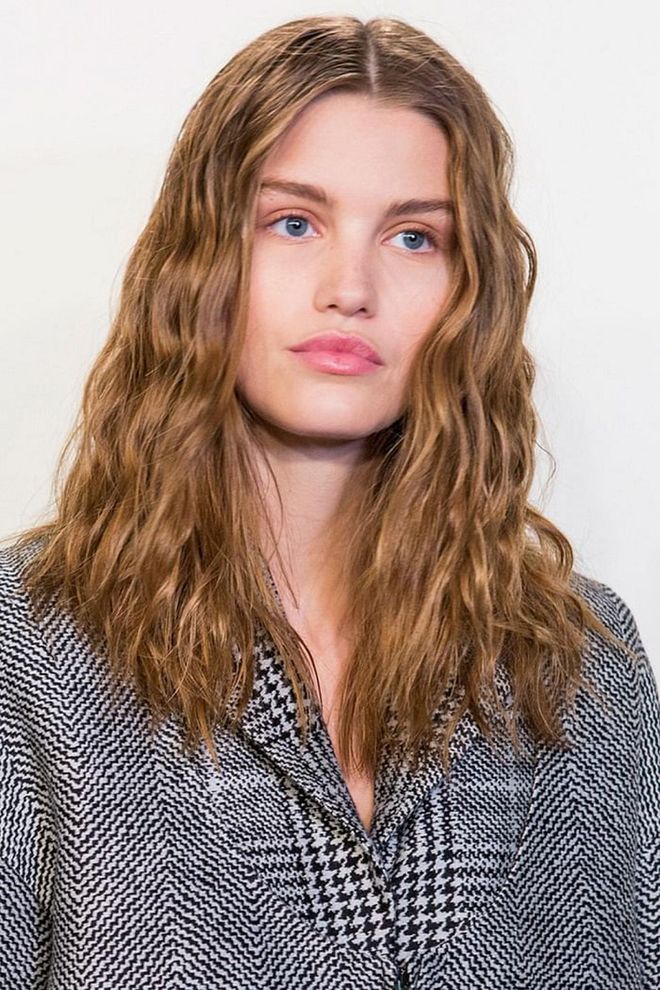 It was all about crimped curls backstage at Fendi. If the models didn't have them naturally, then hairstylists parted their hair into small sections and used a curling iron to fake it. 