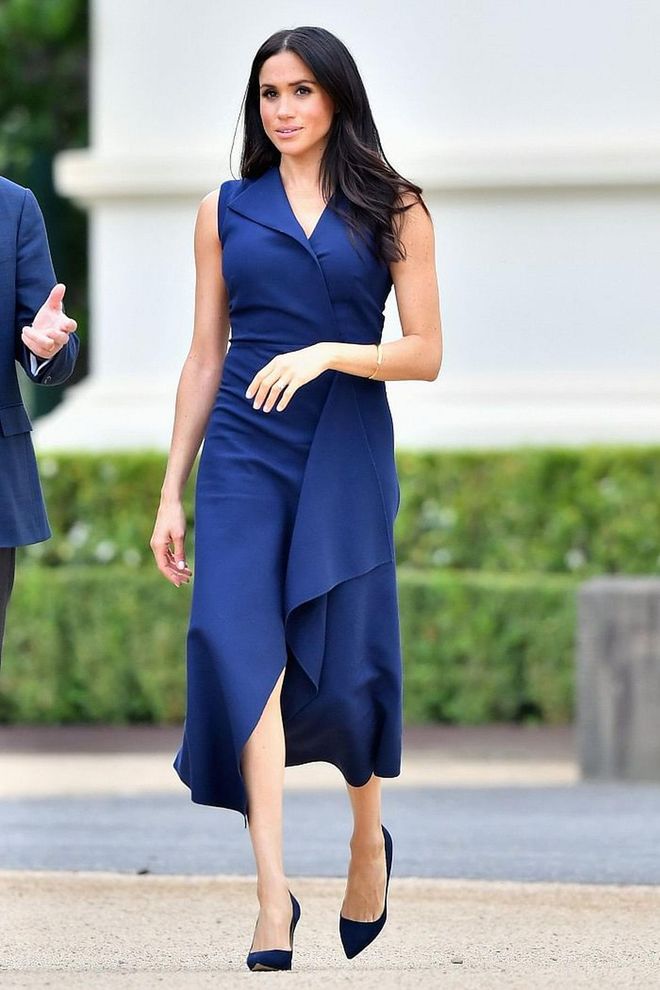 The Duchess of Sussex loves her blues! She wore a sleeveless navy blue dress from Australian designer, Dion Lee for Day 3 of her royal tour. She chose matching Manolos and accessorized with a mini Gucci Sylvie bag. 
