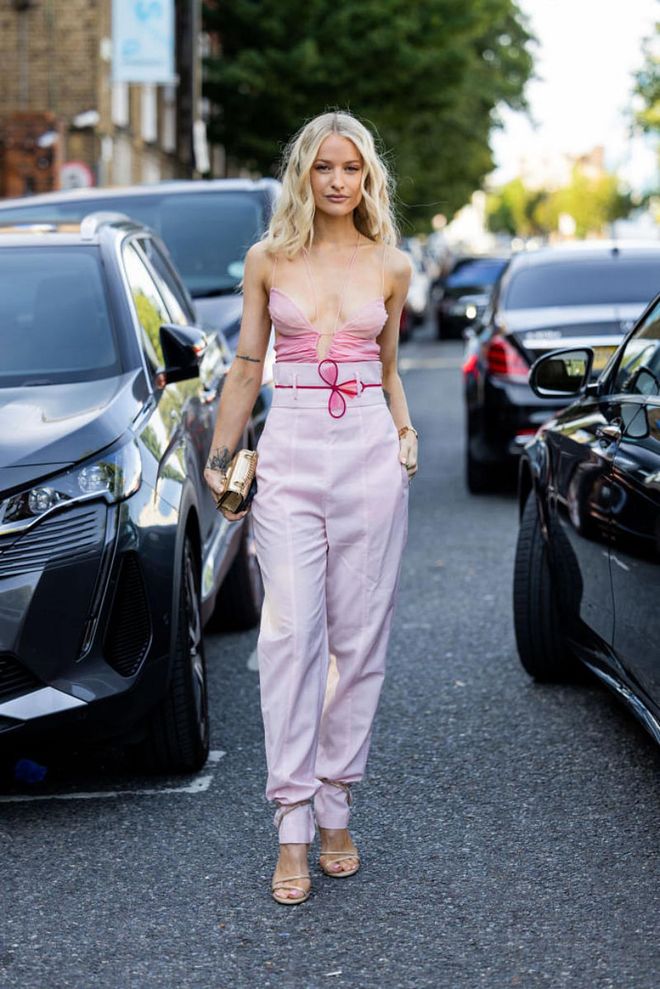 LONDON, ENGLAND - SEPTEMBER 18: Victoria Magrath wears pink top, high waisted rose pants outside Nensi Dojaka during London Fashion Week September 2022 on September 18, 2022 in London, England. (Photo by Christian Vierig/Getty Images)