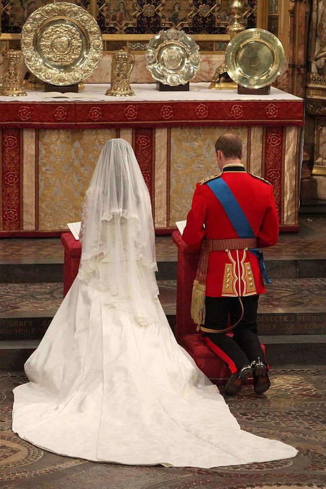 The Prince and his bride kneel at the altar of the Abbey.
Photo: Getty
