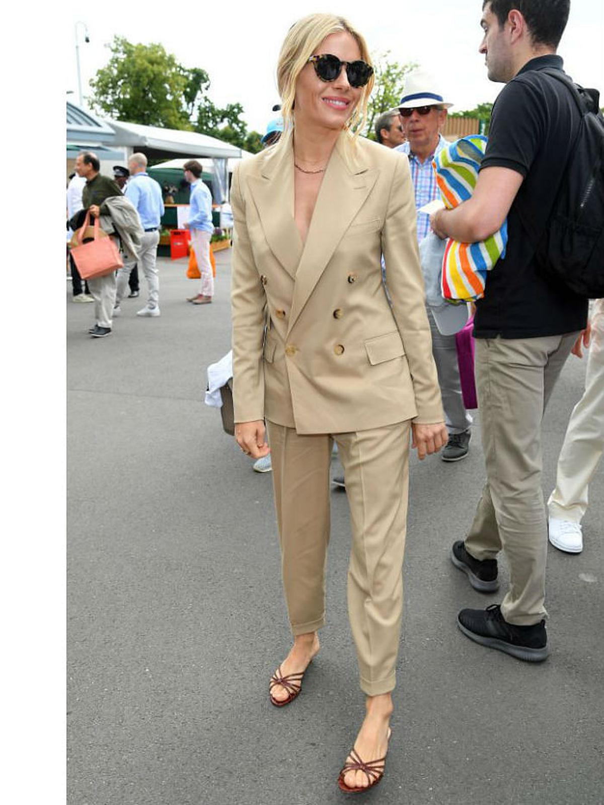 Deepika Padukone styled her white camisole + khaki pants with a roomy  Burberry tote