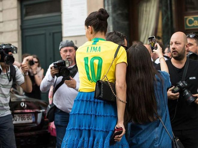 Adriana Lima wearing a Brazilian football shirt during Couture Fashion Week
Photo: Getty