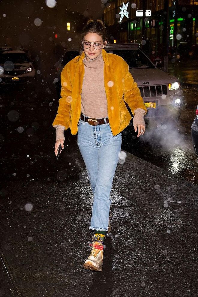 On a chilly winter night in NYC, Gigi sports a bright yellow faux fur coat by dRA Clothing and the coveted Nike X Off White sneakers. 