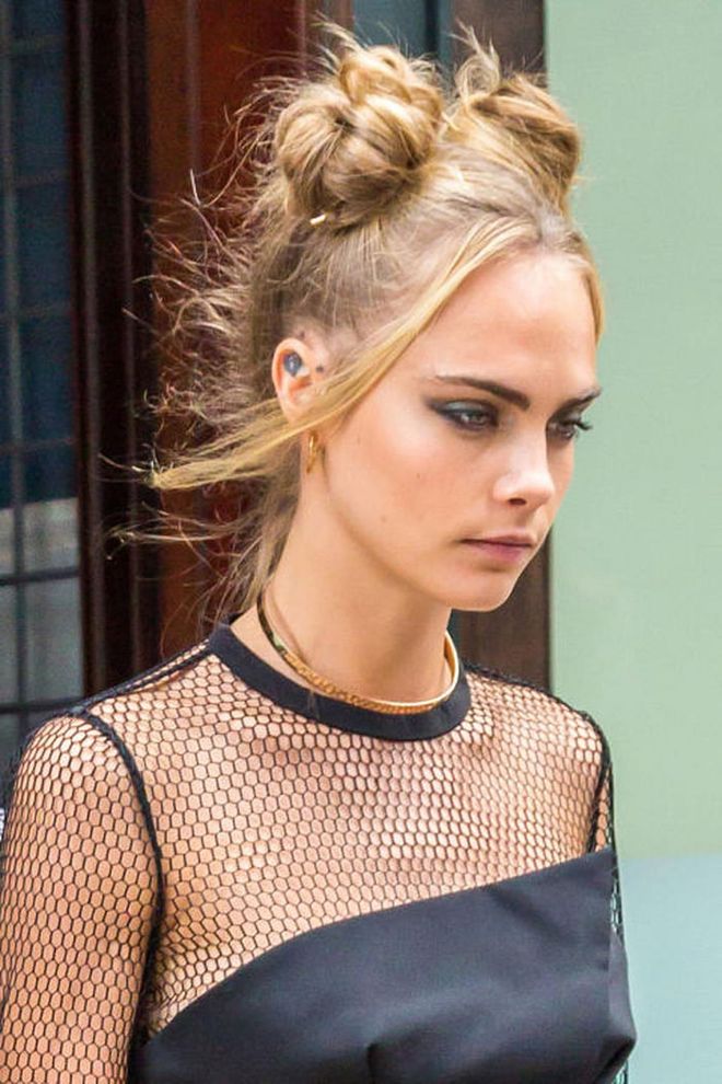 It's the flyaways that make Cara Delevingne's twin top knots look flawless. Photo: Getty