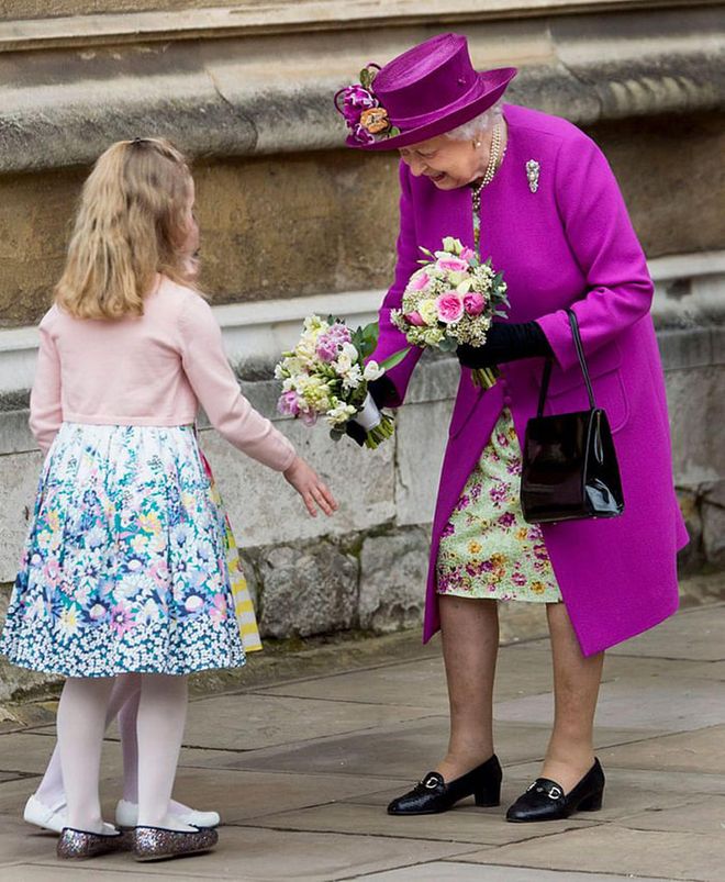 The Queen receives flowers from children outside of St. George's Chapel.

Photo: Getty