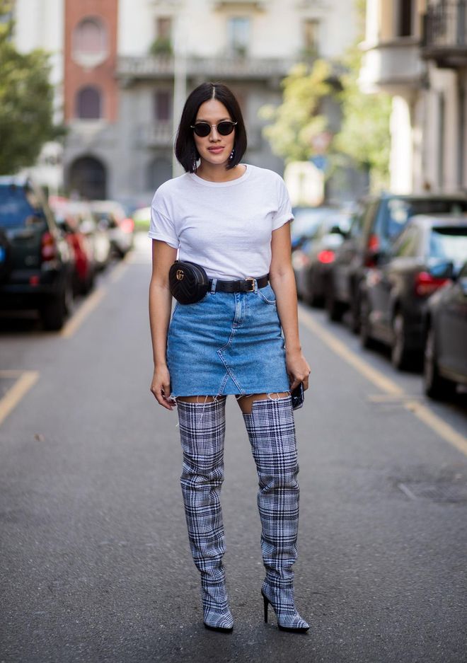 MILAN, ITALY - SEPTEMBER 24: Tiffany Hsu wearing checked overknee boots, Gucci belt bag, denim mini skirt, white tshirt is seen outside Dolce &amp; Gabbana during Milan Fashion Week Spring/Summer 2018 on September 24, 2017 in Milan, Italy. (Photo by Christian Vierig/Getty Images)