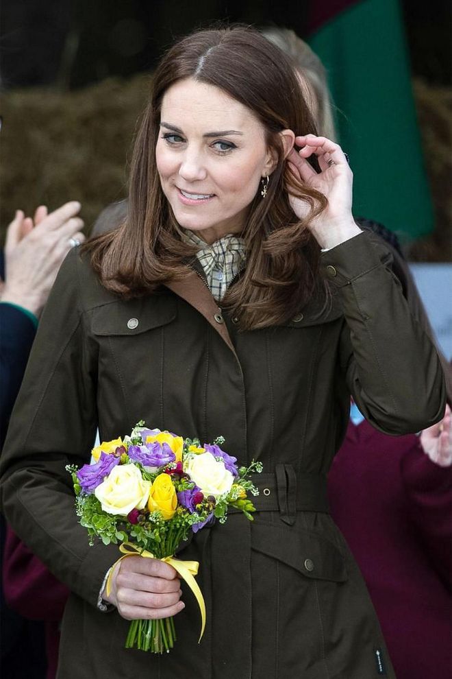 A close-up portrait of Kate at the Teagasc, Animal &amp; Grassland Research Centre. She holds a bouquet of flowers while wearing an olive jacket.

Photo: Getty