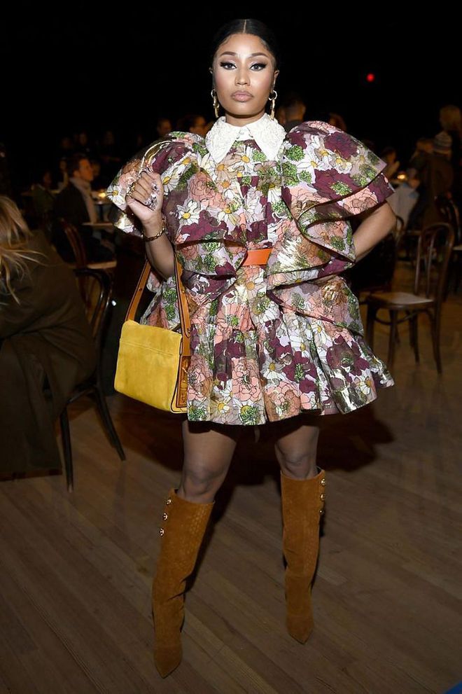 Nicki Minaj styled her ruffled mini-dress with knee-high suede boots.

Photo: Dimitrios Kambouris / Getty