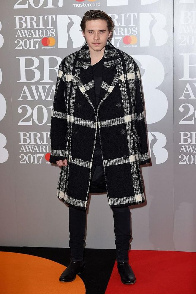Brooklyn Beckham covered up in a checkered coat. Photo: Getty 