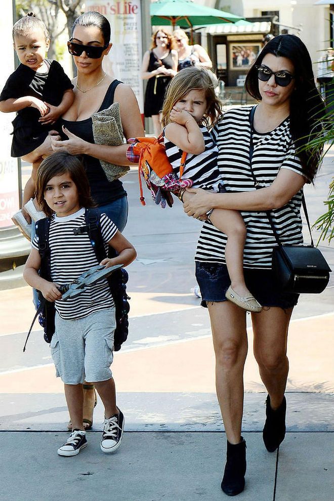 Taking mommy-and-me dressing up a notch, Kourtney Kardshian matched both her son and daughter while out in Los Angeles. All wearing black and white striped t-shirts, the trio channeled their inner Parisians for a simple and chic look.

Photo: Splash News