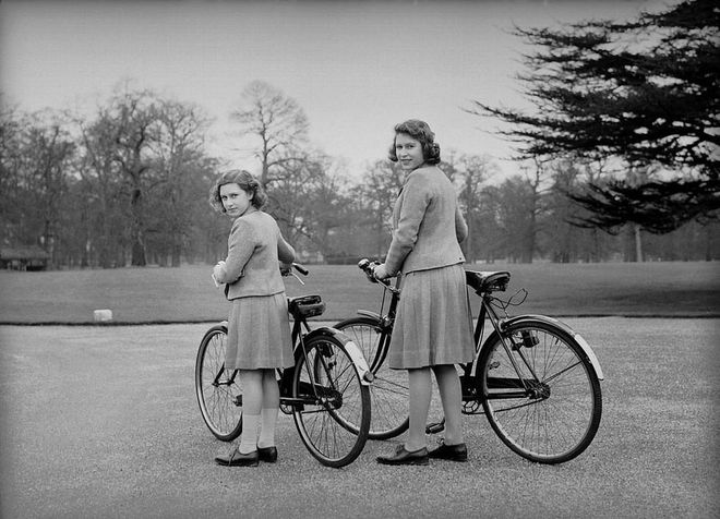 Elizabeth and Margaret head out on a bicycle ride around the grounds of the Royal Lodge in Windsor.
Photo: Getty 