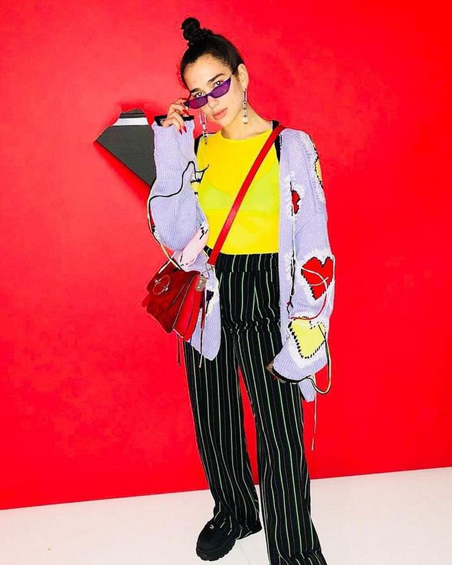 Dua before performing on Jimmy Kimmel Live! in LA. Her yellow sheer top and green pants are from I.AM.GIA, and they are layered over by a Philosophy Di Lorenzo Serafini cardigan, She opts for a J.W. Anderson bag and accessorizes with a pair of Poppy Lissiman sunnies.
Photo: Instagram