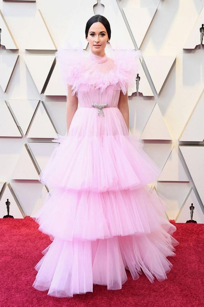 Even in a sea of pink on the Oscars red carpet, Kacey Musgraves was a standout in this layered tulle Giambattista Valli dress with a crystal belt at the waist. The singer wears all that volume like a couture dream.