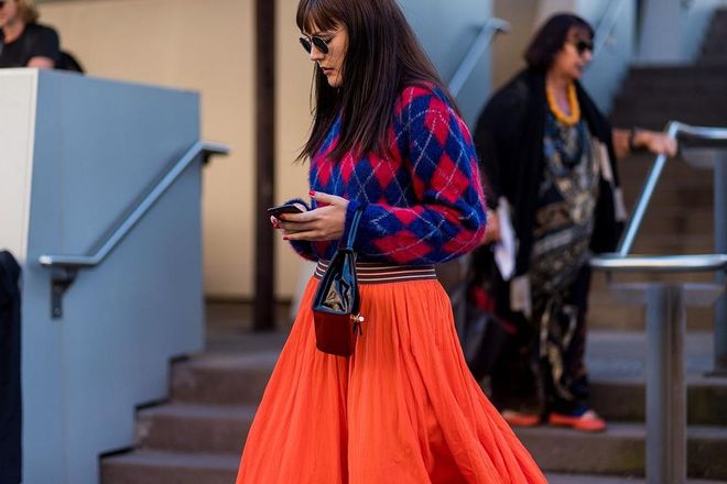 A guest wearing a knit, orange skirt. Photo: Getty 