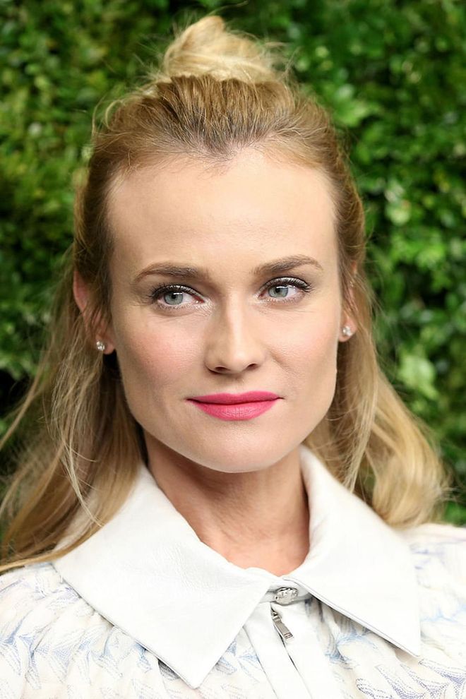 Diane Kruger's slick chignon is the perfect cocktail party hairstyle. Photo: Getty