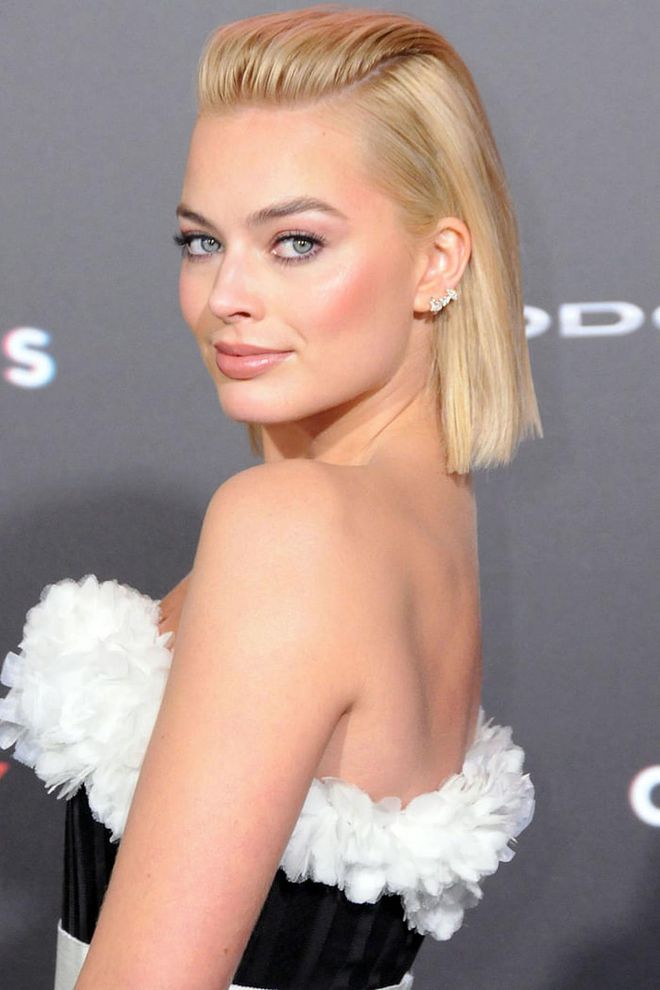 When perfecting this look, plenty of hairspray and a fine comb is necessary. Margot Robbie nails it by creating two deep parts on either side of her forehead (pin at the back with bobby pins), and plenty of volume in front.
